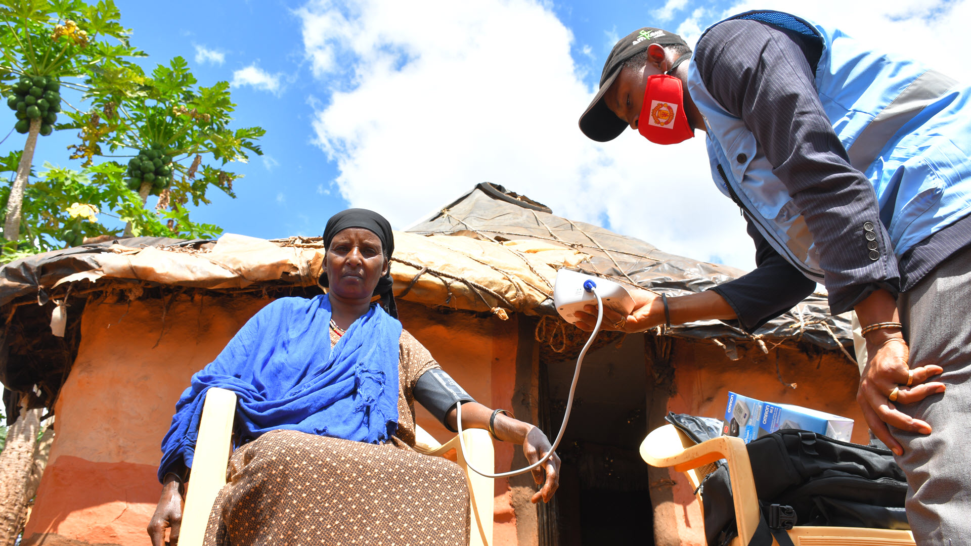 Community health worker takes blood pressure test from a patient in Marsabit County